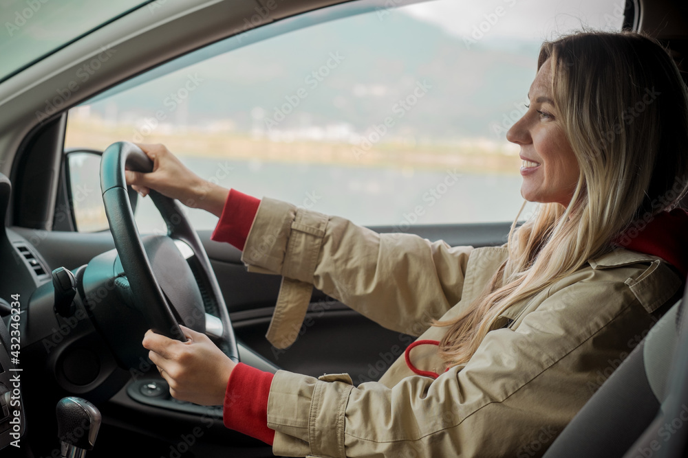 Young stylish woman driving car. Travel, Holidays, Journey, Trip, Lifestyle concept. Health care, authenticity, sense of balance and calmness. Young stylish woman driving car. Travel, Holidays, Journey, Trip, Lifestyle concept. Health care, authenticity, sense of balance and calmness.