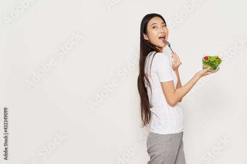 woman of asian appearance plate with salad healthy food slim figure