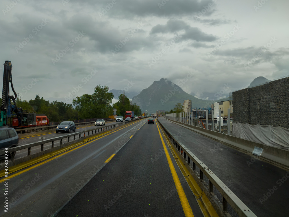 motorway with cars in the mountains after rain