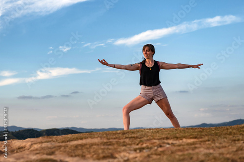 young woman exercising alone outdoor on summer with a big blue sky