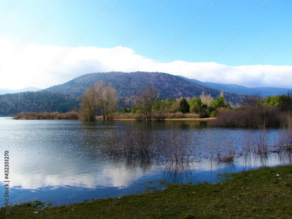 Scenic view of beautiful lake Cerknica or Cerknisko jezero in Notranjska region of Slovenia with blue sky