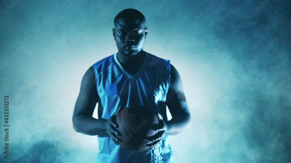African player is holding a basketball in the clouds of smoke African player is holding a basketball in the clouds of smoke