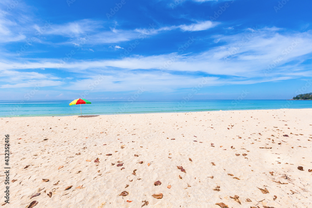 A colourful umbrella on white beach. A colourful umbrella on white beach.