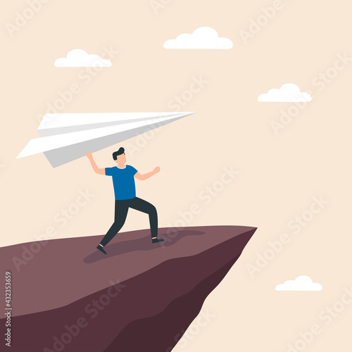 Man holding a paper airplane on cliff edge. Concept of business startup, launch of new project.
