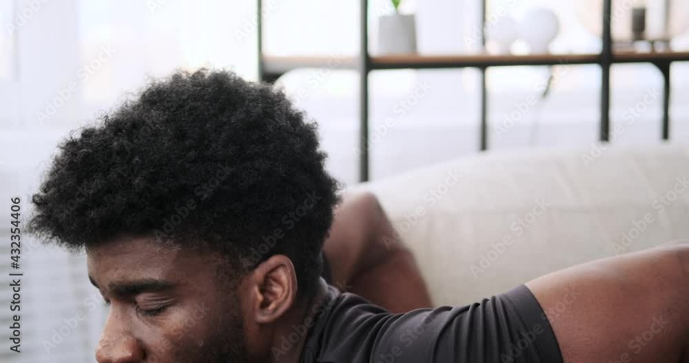African American man doing triceps exercise at home African American man doing triceps exercise at home