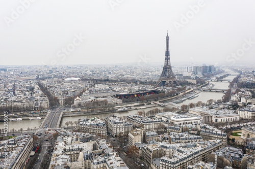 View on Eiffel tower and the river over the roofs of Paris on a grey cloudy day