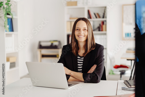 Happy relaxed businesswoman with a friendly smile Free Download Happy relaxed businesswoman with a friendly smile - GFXLoad