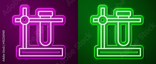 Glowing neon line Glass test tube flask on stand icon isolated on purple and green background. Laboratory equipment. Vector
