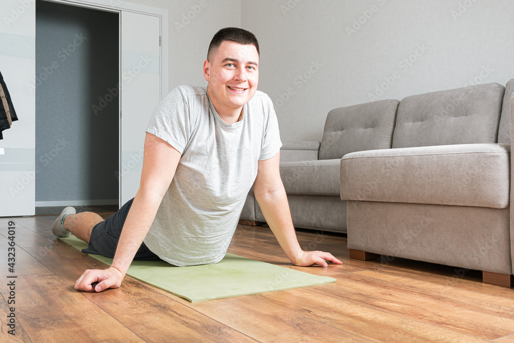Fototapeta premium Man doing exercises at home