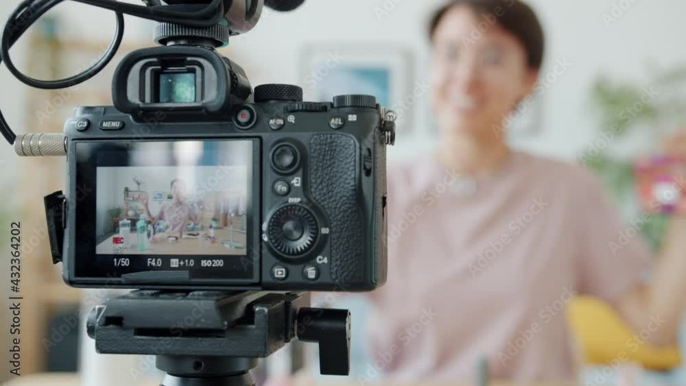 Close-up of video camera with female vlogger recording video about cosmetics on screen. Modern technology and creative social media contect concept. Close-up of video camera with female vlogger recording video about cosmetics on screen. Modern technology and creative social media contect concept.