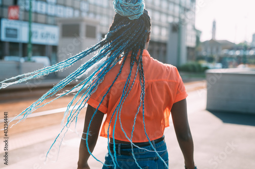 Rear view unrecognizable bblack woman with blue braid hair outdoor photo