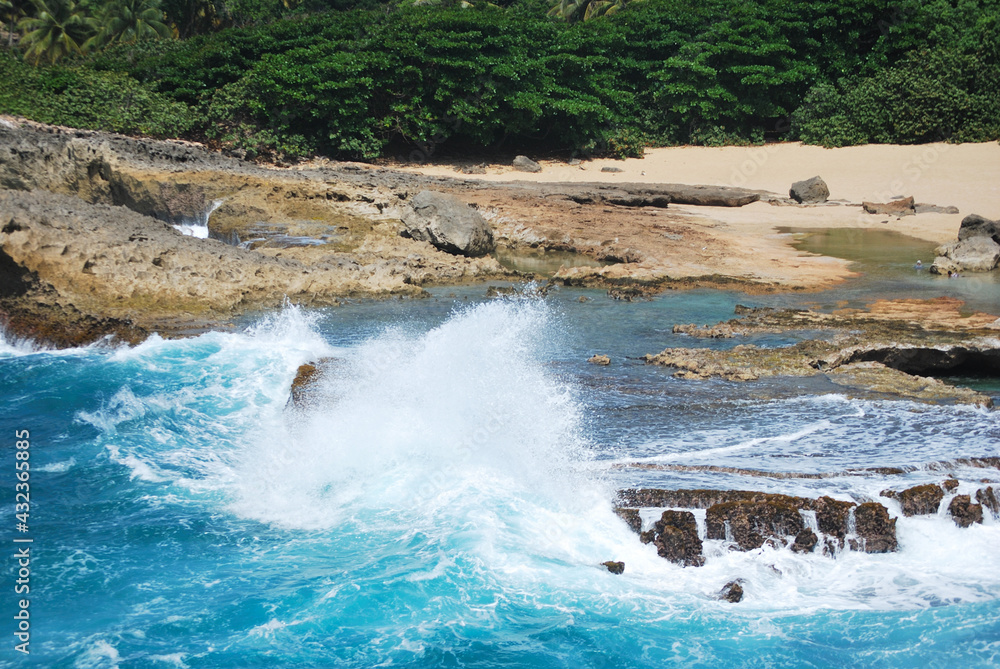 A wave breaking in a rock on the beach A wave breaking in a rock on the beach