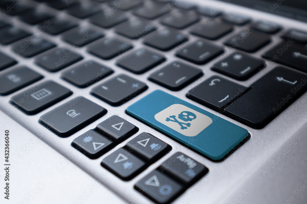 Laptop keyboard with a blue key with a painted skull. Danger concept, hacker Laptop keyboard with a blue key with a painted skull. Danger concept, hacker