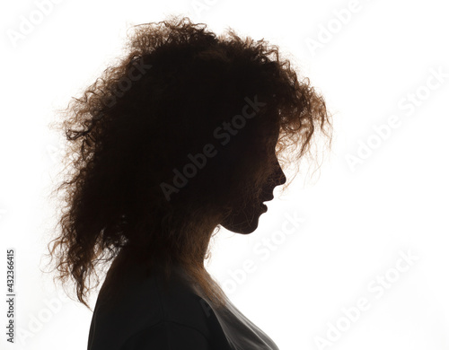 Silhouette of beautiful girl with curly hair isolated on white background.