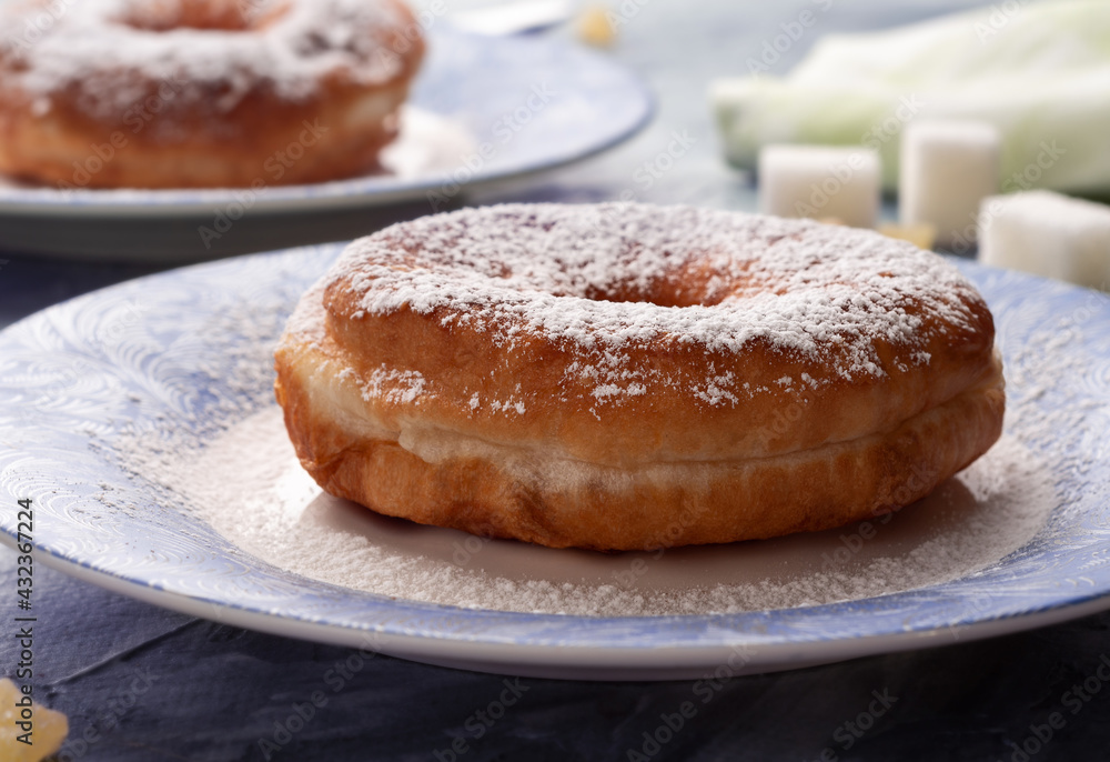 Classic doughnut sprinkled with powdered sugar. Sweet doughnuts.