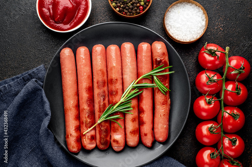 Grilled sausages on stone background