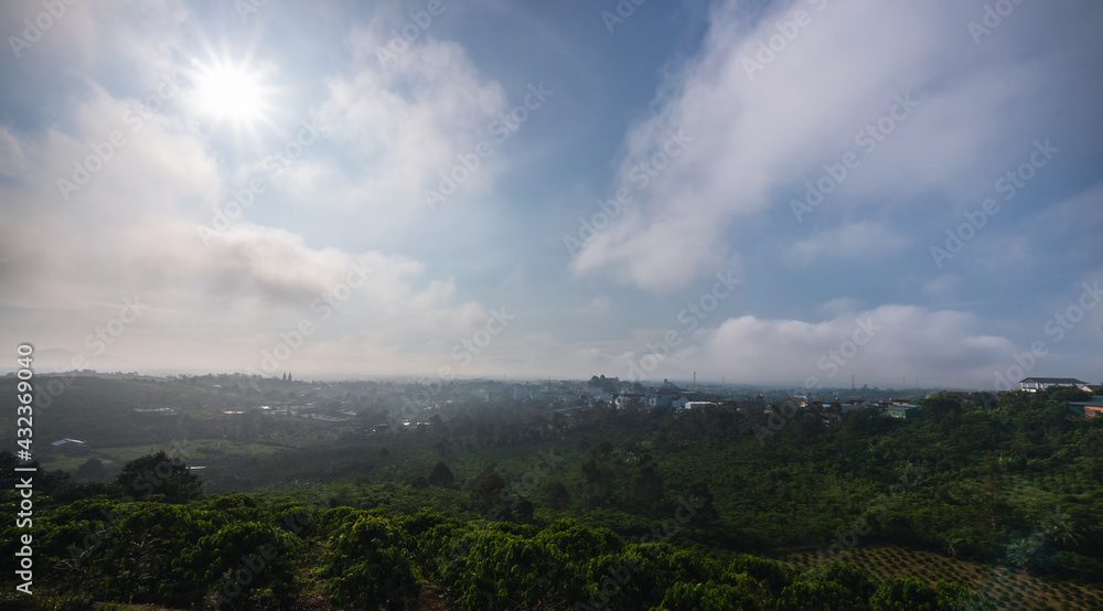 Sun rays and misty at the valley on Bao Loc town. The far side is Tan Hoa Church in Lam Dong province, Vietnam.