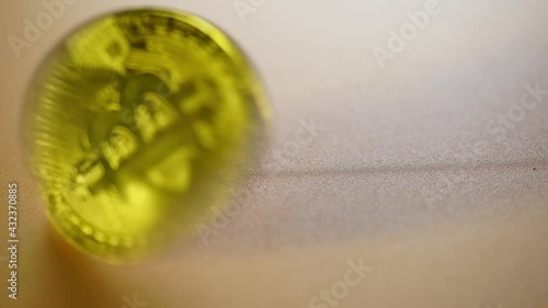 spinning bitcoin on wooden table top