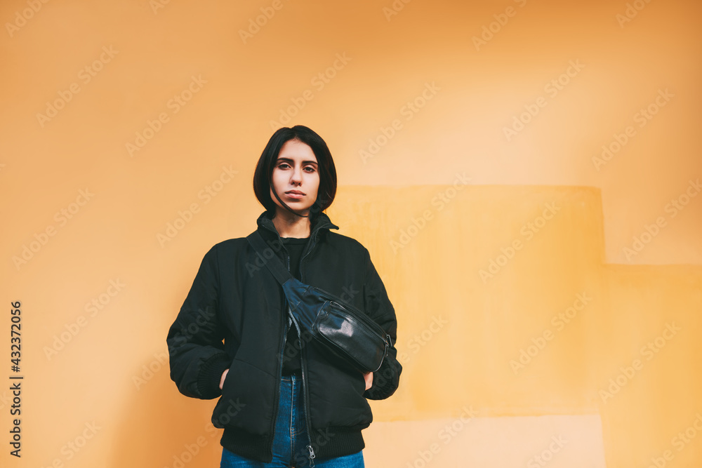 Serious woman with hands in pockets Serious woman with hands in pockets