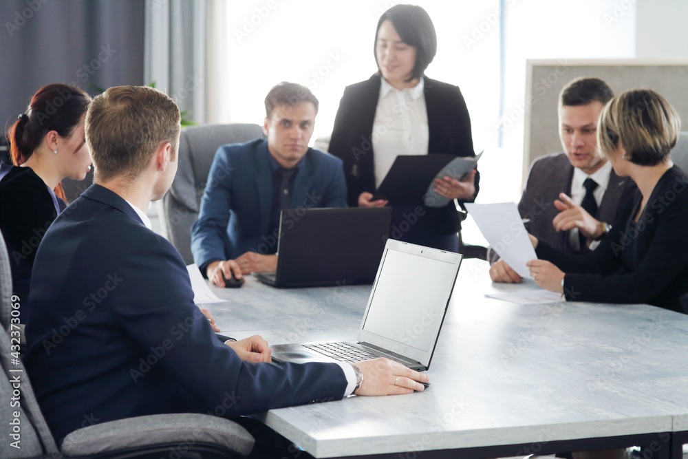 Group of young business people meeting in the office discussing an important idea together Group of young business people meeting in the office discussing an important idea together
