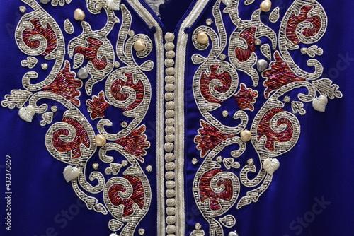 Quadro em tela Details of a blue Moroccan caftan for women,  and golden lace