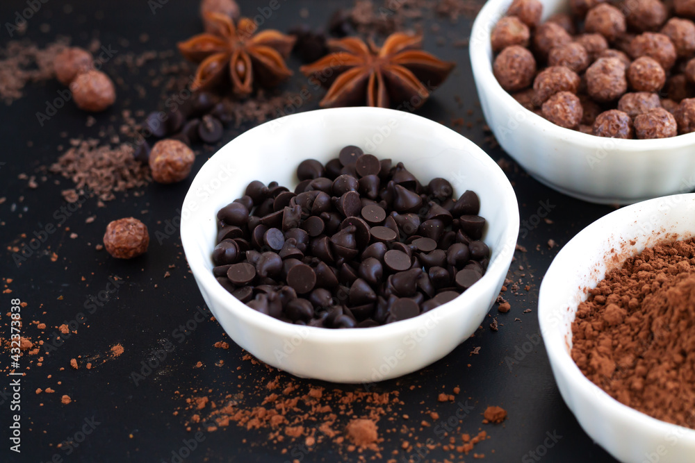 Dessert cooking ingredients background chocolate morsels and cocoa powder Dessert cooking ingredients background chocolate morsels and cocoa powder
