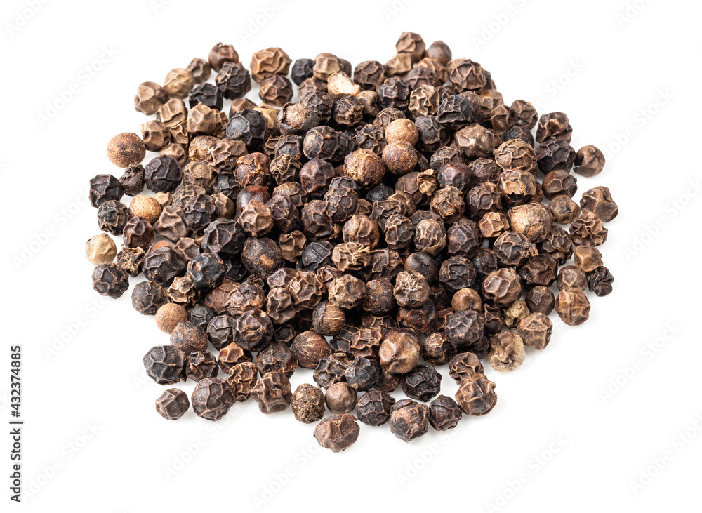 handful of black pepper peppercorns on white handful of black pepper peppercorns on white