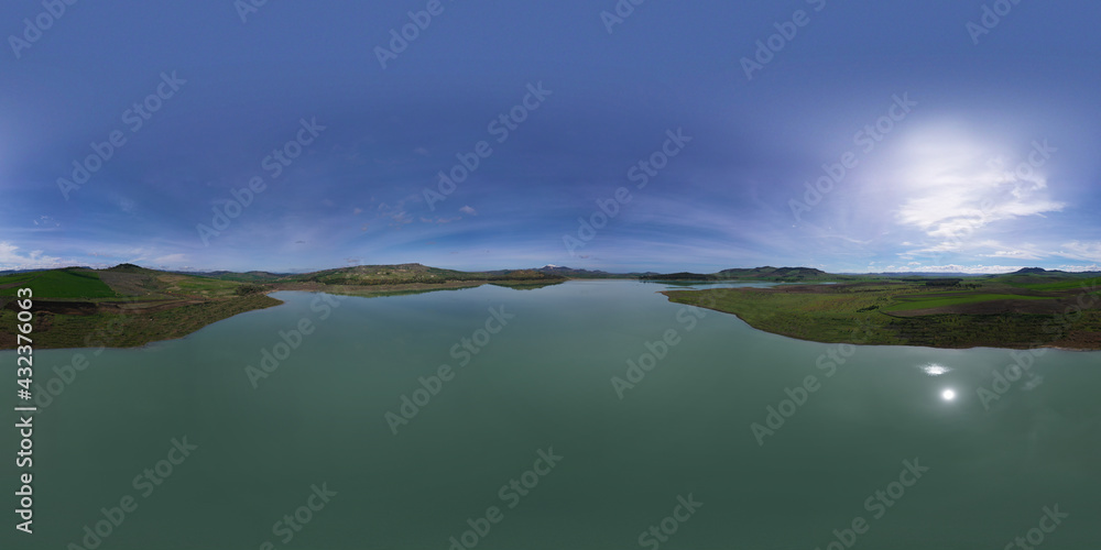 360 degree aerial photo of Ogliastro lake in the heart of Sicily with Etna view. Place of great naturalistic value surrounded by hills planted with cereals. A destination for migratory bird species.