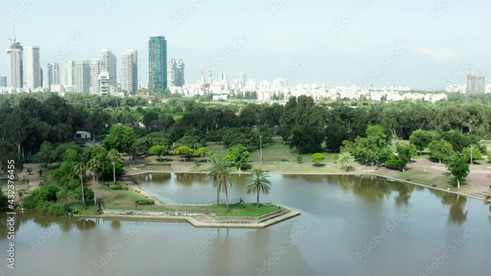 Aerial Panning Shot Of Beautiful River At Yarkon Park, Drone Flying Over Water Against Sky - Tel Aviv, Israel Aerial Panning Shot Of Beautiful River At Yarkon Park, Drone Flying Over Water Against Sky - Tel Aviv, Israel