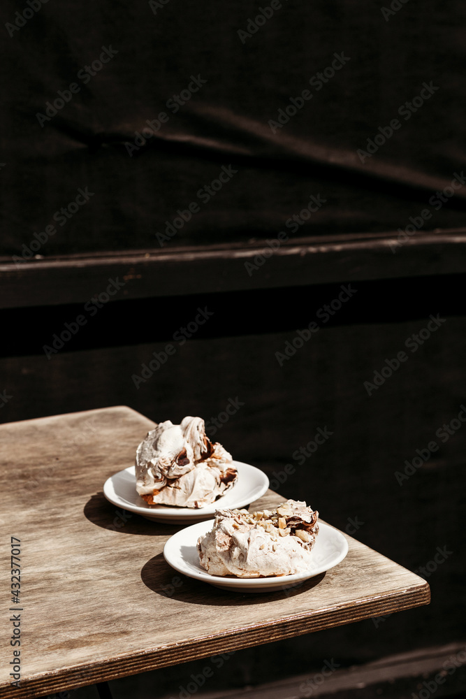 Cream dessert of airy Italian meringue. Party food concept, cafe. Place for text. Postcard for the holiday