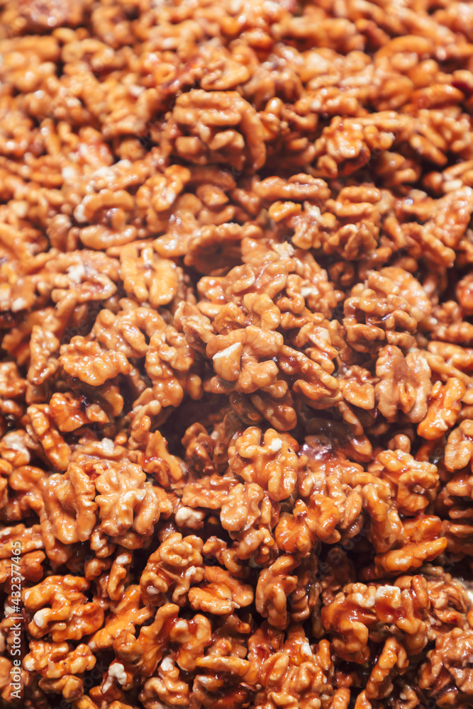 Heap of walnuts in sugar glaze. Sweet walnut dessert (Selective focus)