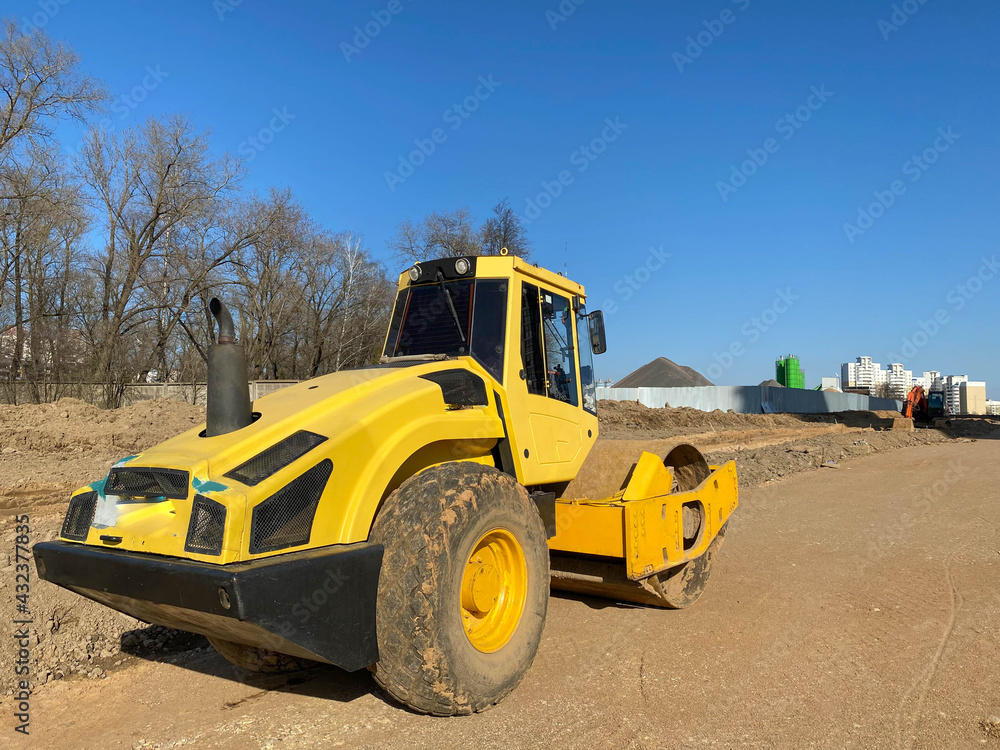 Construction site is laying new asphalt road pavement,road construction workers and road construction machinery scene.highway construction site landscape