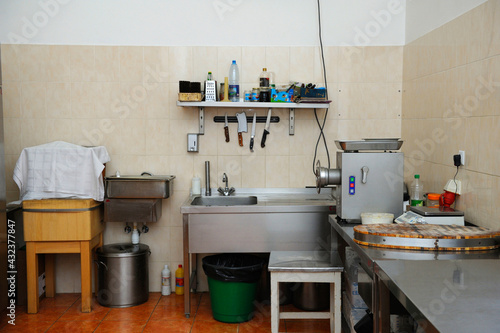 In the kitchen: butcher's knives, blender, sink, cutting desk and other kitchen utensils © Yurii Zushchyk