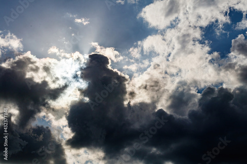 Cumulonimbus Storm Clouds with Sun Starburst Lens Flare Effect photo