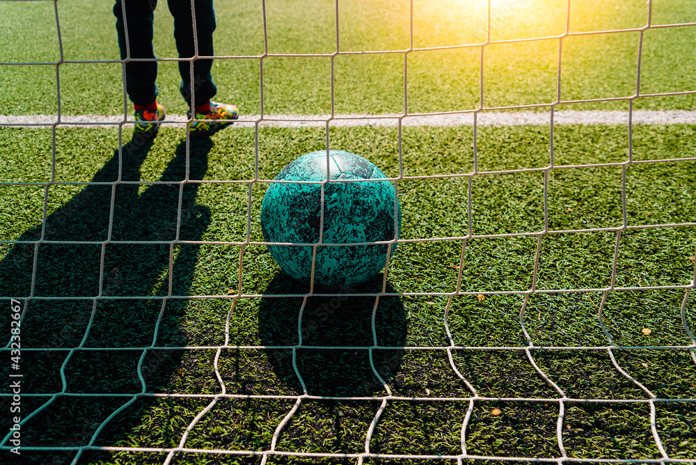 Soccer ball entering a goal defended by a goalkeeper, copy space Stock