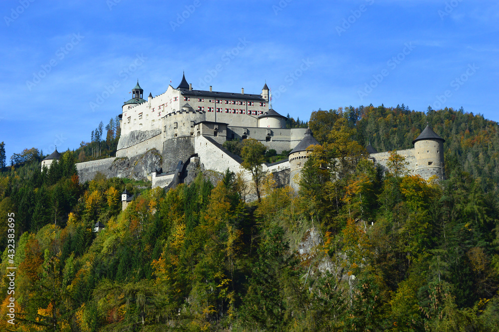 Hohenwerfen Castle, Salzach Valley Austria. The huge imposing fortress sits above a hill, surrounded by trees and is a popular tourist attraction.