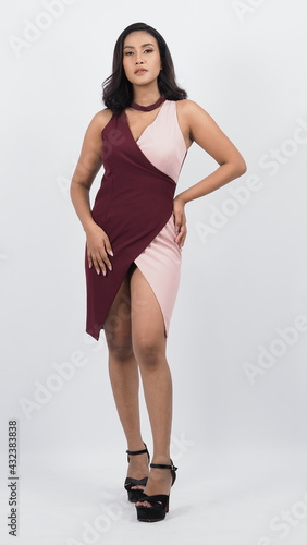 Sexy business woman red dress posing in studio white background. Sexy Asian black hair girl with full lips gesturing to camera. Attractive business female with big breast. posing in studio shooting. 