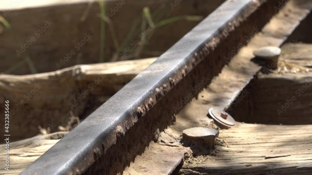 Abandoned rusted railroad rail and rail road ties with shadows of tree branches. Abandoned rusted railroad rail and rail road ties with shadows of tree branches.