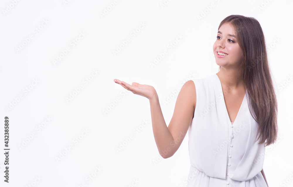 Beautiful happy business girl shows on pointing at copy space on a white background.Copy space. Beautiful happy business girl shows on pointing at copy space on a white background.Copy space.