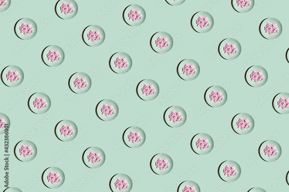 Minimalistic pattern concept with mint plates and pink bright flowers on pastel background. Geometric colorful composition. Minimalistic pattern concept with mint plates and pink bright flowers on pastel background. Geometric colorful composition.