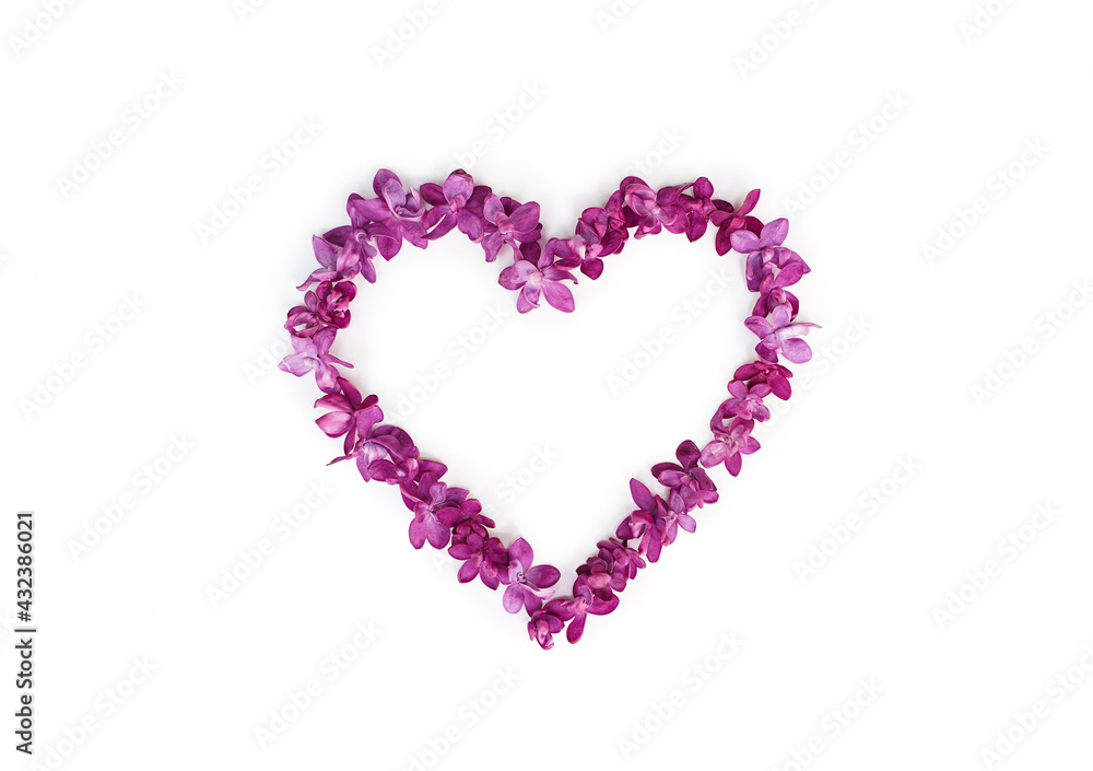 Heart made of lilac flowers isolated on a white background. Top view, copy space.