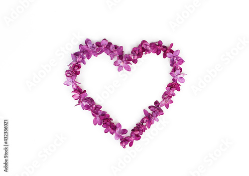 Heart made of lilac flowers isolated on a white background. Top view  copy space.