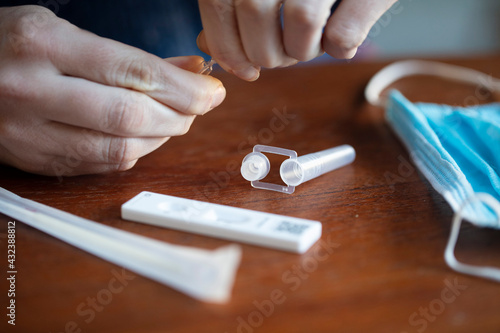 Close up of a person using coronavirus covid-19 rapid antigen home testing kit photo