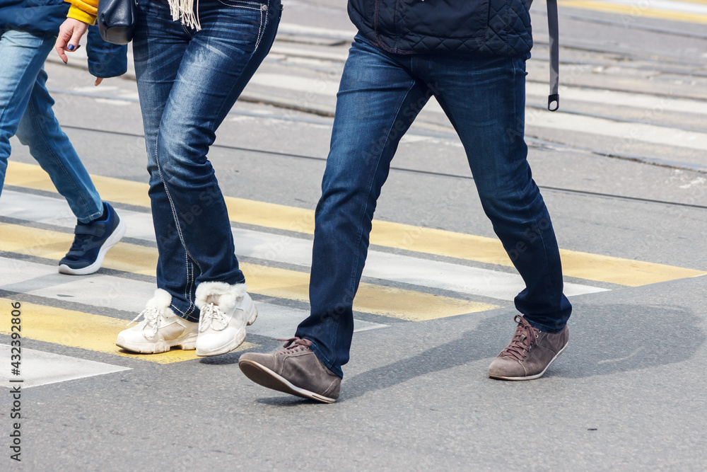 pedestrians cross the street at a pedestrian crossing pedestrians cross the street at a pedestrian crossing