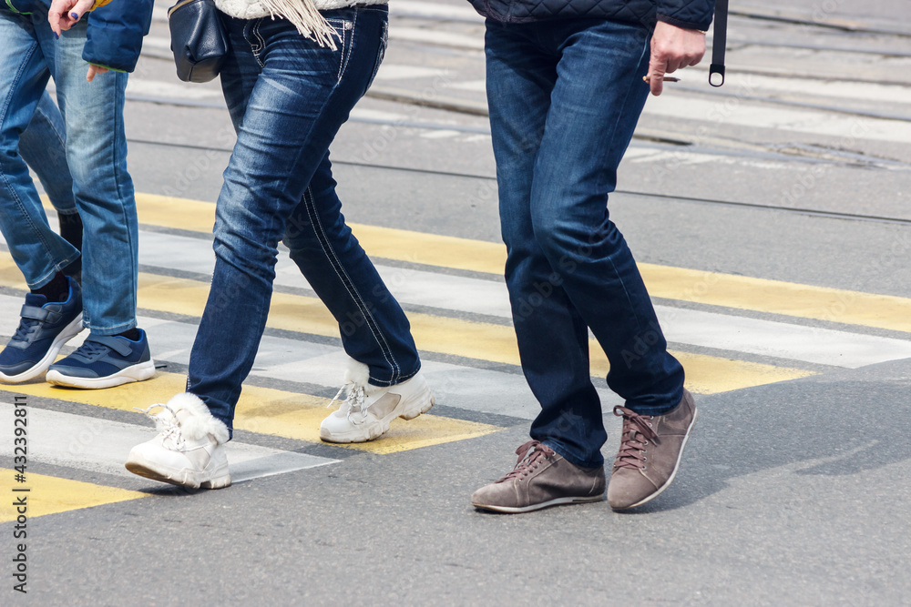 pedestrians cross the street at a pedestrian crossing pedestrians cross the street at a pedestrian crossing