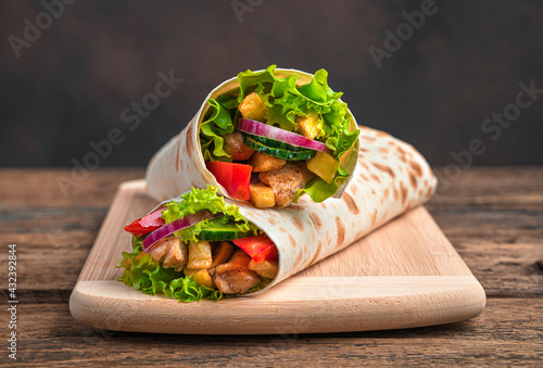 Traditional oriental shawarma close-up on a brown background.