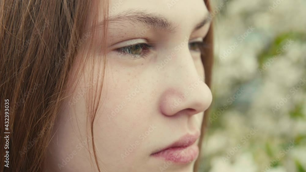 Beautiful young woman in a dark denim jacket in the spring garden in bloom, spring cherry trees blossom, harmony with nature, seasonal spring scene. Slow motion video. Beautiful young woman in a dark denim jacket in the spring garden in bloom, spring cherry trees blossom, harmony with nature, seasonal spring scene. Slow motion video.