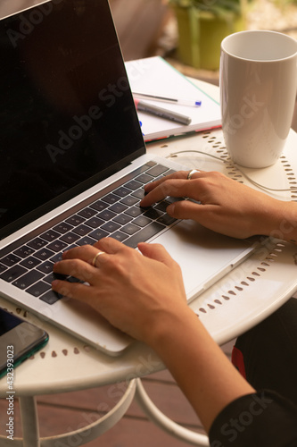 close-up of a pair of business woman hands typing in a brand new laptop 