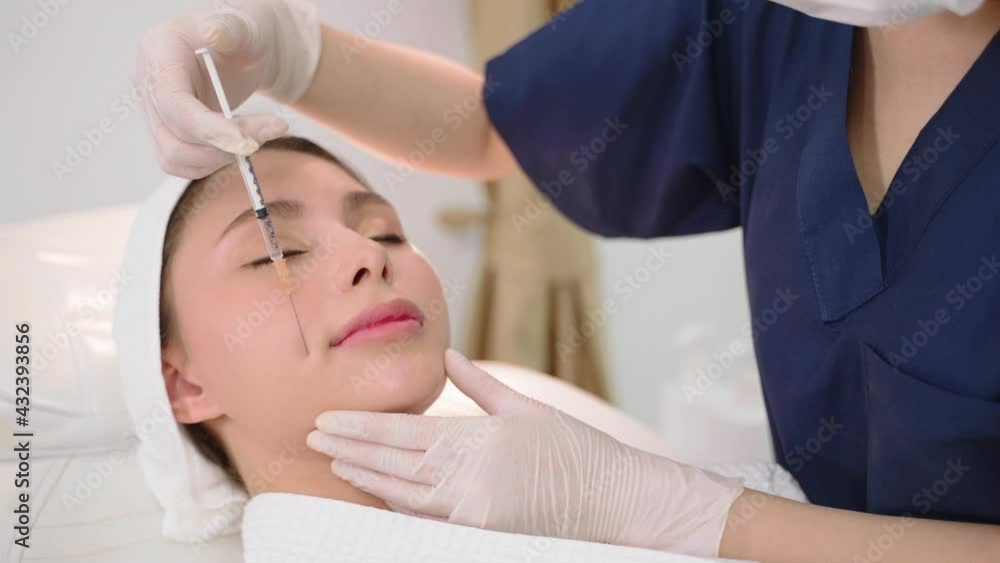 Beautician makes botox injection in the face. beautician makes a treatment procedure to the patient. A beautician gives injections to a woman's face. Beautician makes botox injection in the face. beautician makes a treatment procedure to the patient. A beautician gives injections to a woman's face.