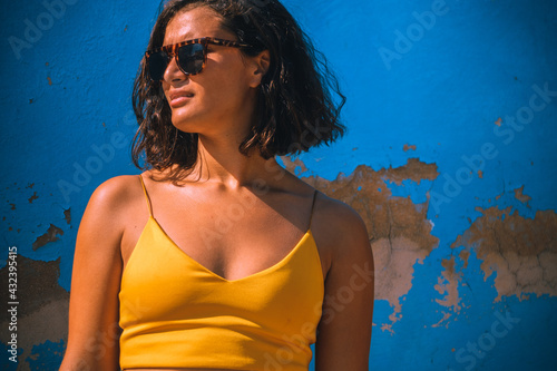 young woman in front of blue wall